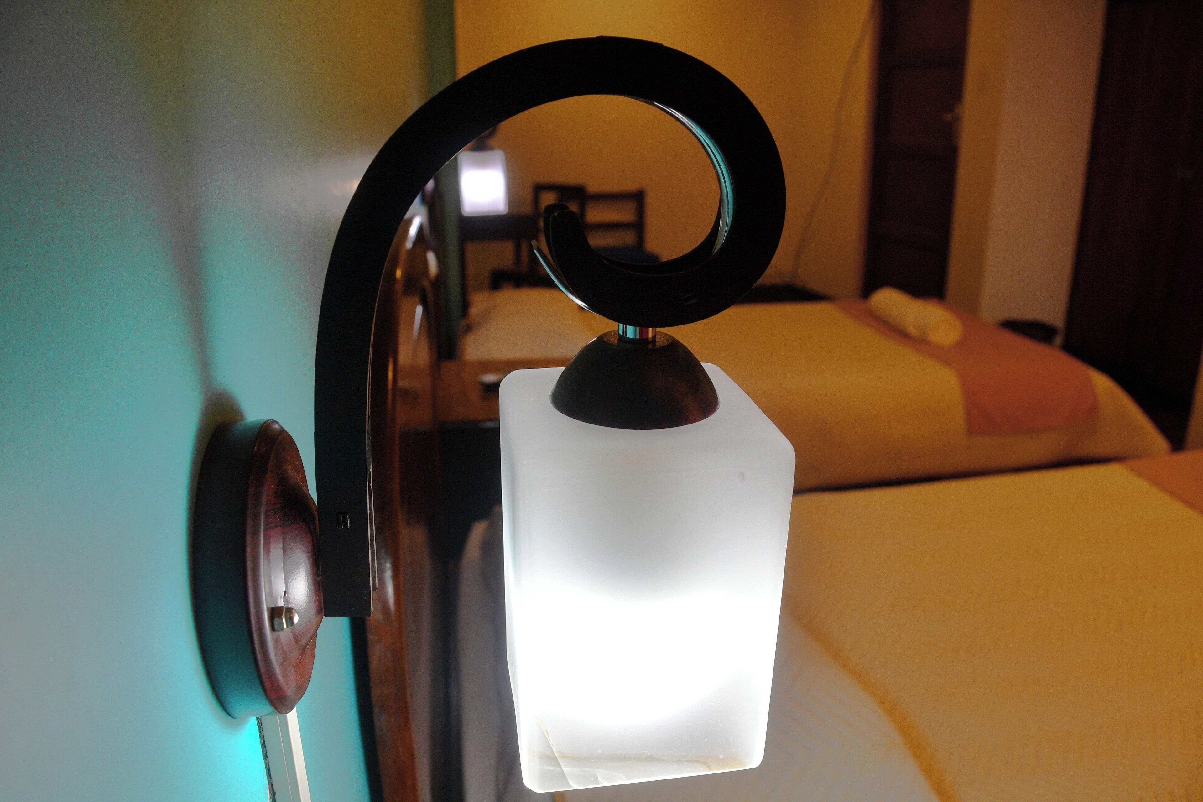 A bed with a white headboard, a bedside table, and a nightstand.