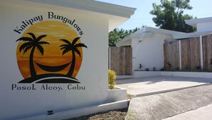 A wall with the text "Kalipay Bungalows Pasol, Alcoy, Cebu" and a sunset graphic. - Kalipay Bungalows (Alcoy)