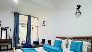 A hotel room with a large bed, a desk, and a chair. There is a window with curtains, a ceiling fan, and a wall-mounted light fixture. - HERITAZ VILLA ELLA (Ella)