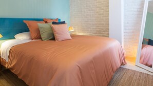A hotel room with a bed, pillows, a nightstand, a lamp, and a mirror. - Central and bright apartment with balconies (Málaga)