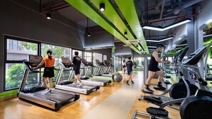 A gym with treadmills, exercise balls, and weight machines. - Eco Green Apartment- Minimalist Home (Ho Chi Minh City)