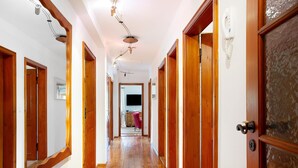 A hallway with wooden doors, a wooden floor, and a ceiling with hanging lights. - Holiday Home 'Ferienhaus Auszeithaus' with Private Terrace, Private Garden and Wi-Fi (Zell/Ebenhausen)