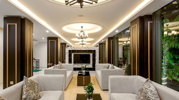 A modern living room with a sofa set, a coffee table, and a TV. - Doji Stars (Da Nang)