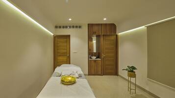 Cozy retreat with a neatly made bed, a wardrobe, and a bedside table.