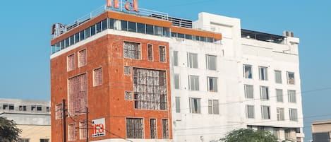 A multi-story building with a prominent sign on the top.