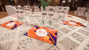 A conference table with water bottles, name cards, and a logo. - IRA by Orchid Sambhajinagar - Aurangabad (Chhatrapati Sambhajinagar)