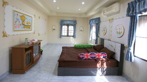 A bedroom with a bed, a wooden cabinet, and a window with curtains.
