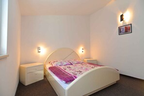 Cozy retreat with a single bed, bedside tables, and a framed picture on the wall.