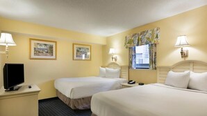 A hotel room with two beds, a television, and two framed pictures on the wall. - Coastal Bliss Ocean View 2BR Condo on 3rd Floor (Myrtle Beach)