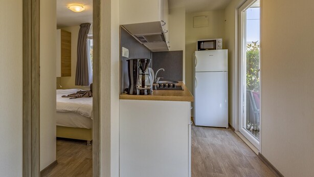 A compact kitchenette with a microwave, coffee maker, and a small refrigerator. - Mobile Homes with Shared Pool Rocco 2 (Medulin)