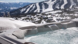 A hot tub with a mountain view.