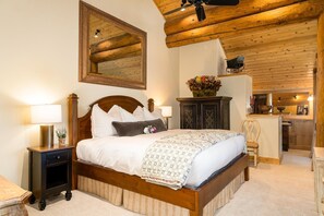 Cozy retreat with a large bed, wooden headboard, and a spacious mirror.