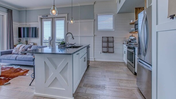 A modern kitchen with a central island, built-in appliances, and pendant lighting. - FantaSea On 30A - Gulf View / Pickleball / Deeded Beach Access (Santa Rosa Beach)