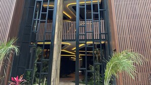A modern building with a sign reading "AMMA DISTRICT B". - OVA CANCUN Y TULUM (Tulum)