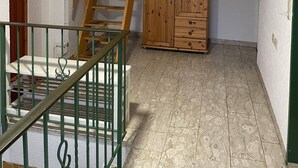 A room with a wooden staircase, a wardrobe, and a radiator. - Apartment Beny (Bad Bellingen)