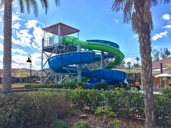A water park with multiple slides and a covered viewing platform.