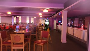 A restaurant with tables and chairs, a counter, and a neon sign. - 3 bed Static 12ft Caravan Home From Home Somerset (Watchet)