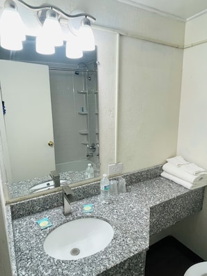 Bathtub, towels, soap, shampoo