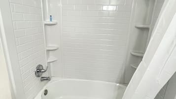 Bathtub, towels, soap, shampoo