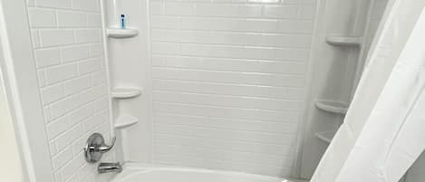 Bathtub, towels, soap, shampoo