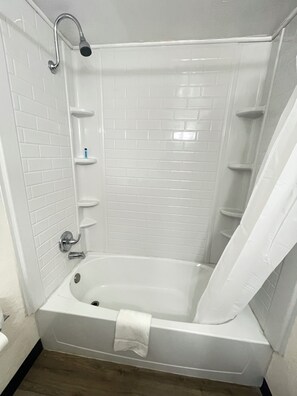 Bathtub, towels, soap, shampoo