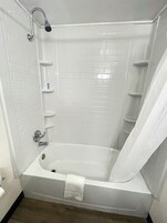 Bathtub, towels, soap, shampoo