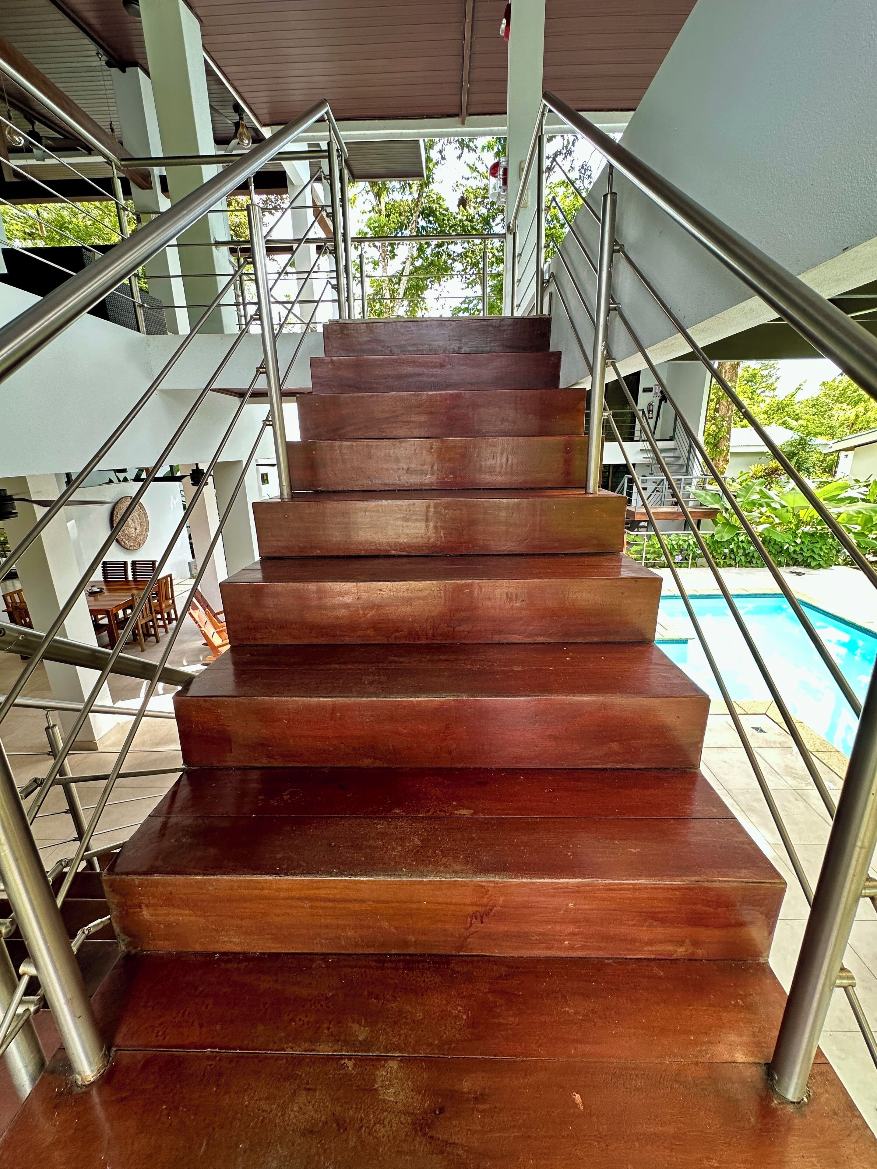 A staircase with metal railings leading to an upper level.