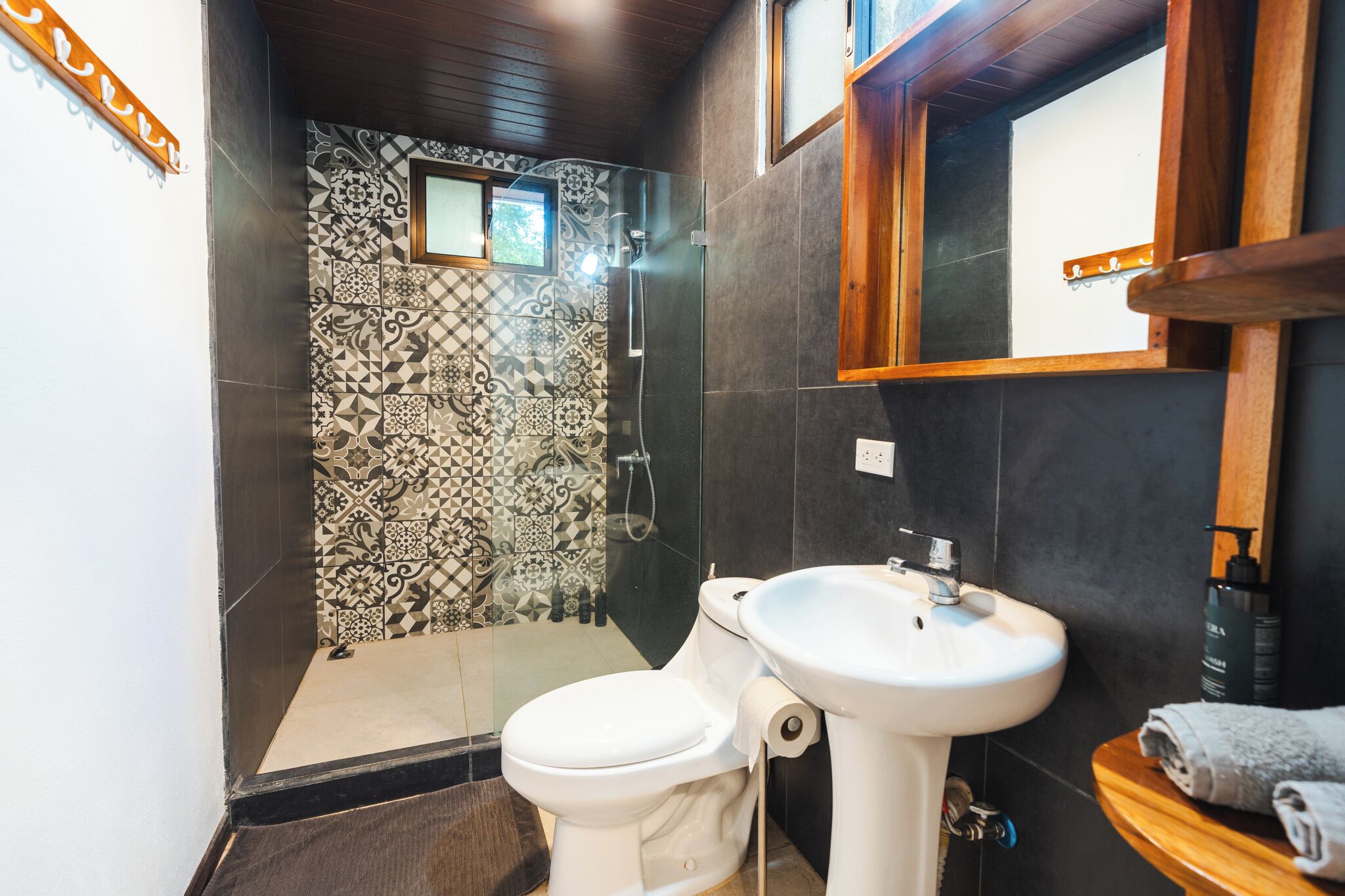 A bathroom with a shower, toilet, and sink.