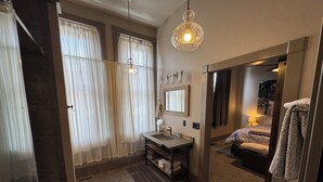 A modern bathroom with a sink, mirror, and towel rack. - “The Roost” downtown Red Lodge, MT (Red Lodge)