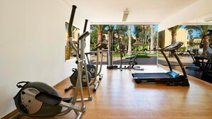 A gym with cardio equipment, weight machines, and a treadmill. - Rosa Atlantic Apartment (Corralejo)