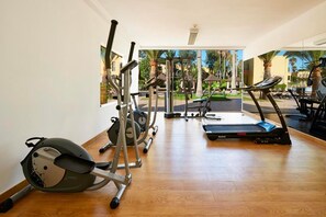 A gym with cardio equipment, weight machines, and a treadmill. - Rosa Atlantic Apartment (Corralejo)