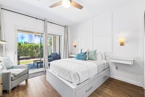 A bedroom with a bed, a chair, a ceiling fan, a sliding glass door, and a nightstand. - Walk to Rosemary Beach w/ Pool. Ground Floor (Panama City Beach)