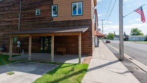 A two-story building with a wooden facade and a flat roof. - Come explore the Western UP! Located right on the atv and snowmobile trail. (Ewen)