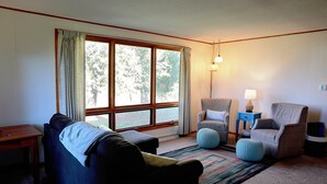 A living room with a sofa, two armchairs, a small table, and a lamp. - The Fox Den Comfy Lower Unit (Lake Elmo)