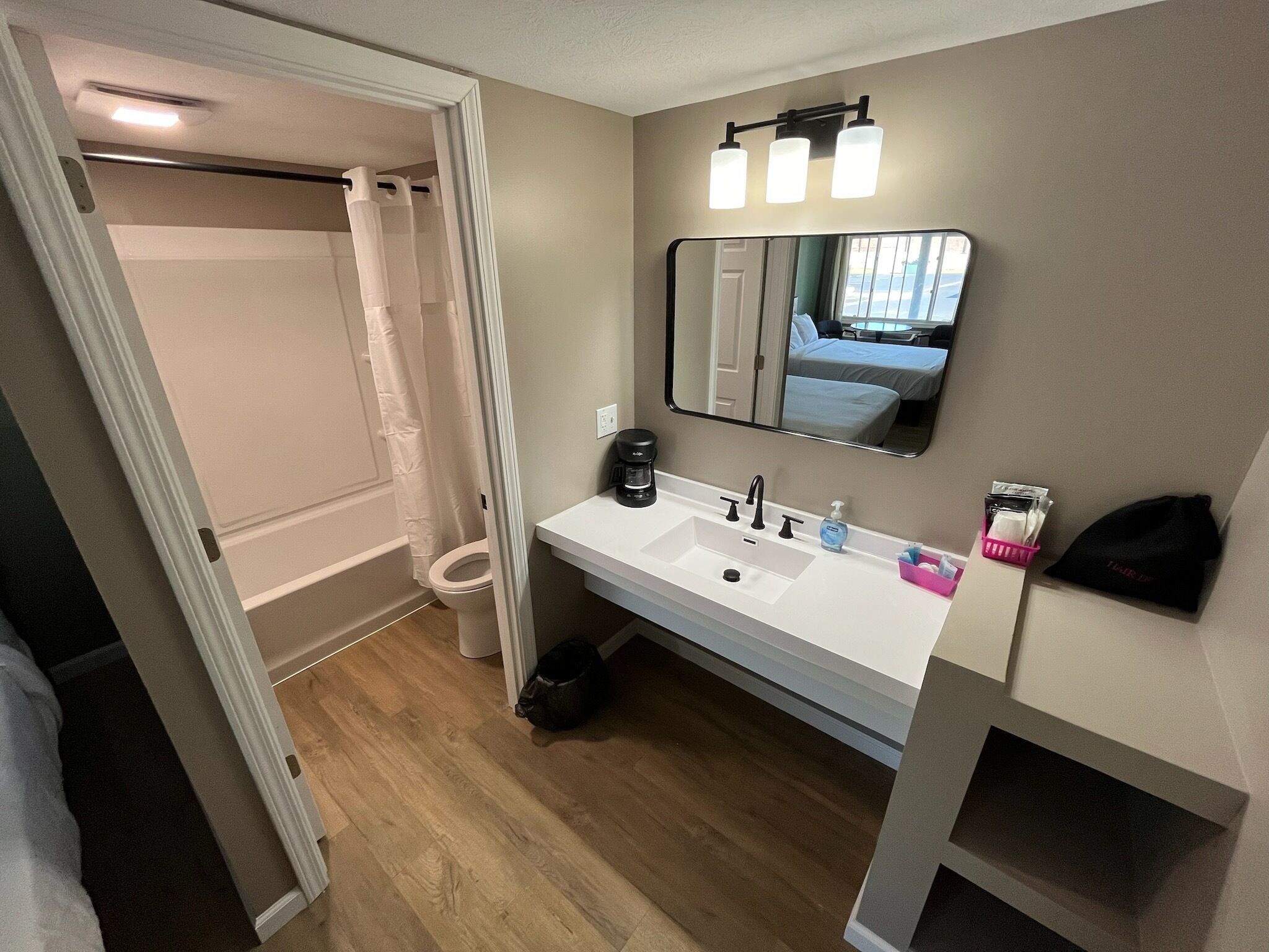 A bathroom with a white sink, a mirror, and a shower curtain.