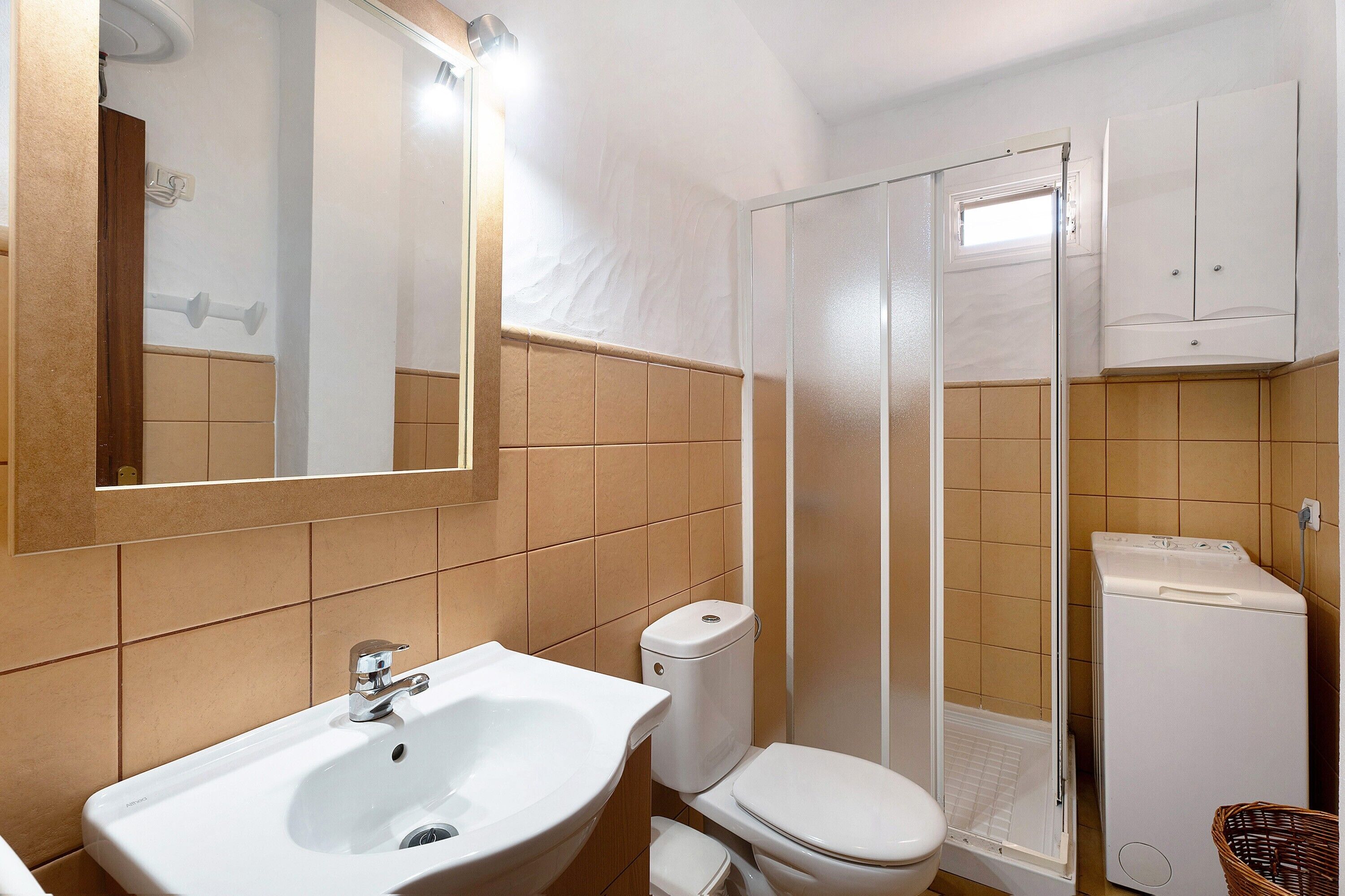A bathroom with a sink, toilet, and shower.