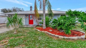 A single-story house with a red door and a number '165' on the front. - My Venice Beach House (South Venice)