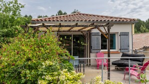 A covered outdoor seating area with a pergola, a table, chairs, and a sofa. - Holiday Home 'Le Pequelet' with Shared Pool, Wi-Fi and Air Conditioning (Payzac)