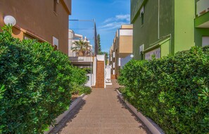 Stroll along the beautifully manicured hedges to the entrance of this residential building.