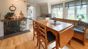 A cozy kitchen with wooden cabinets, a central island, and a dining area with a bench. - 3 bedroom gorgeous home in överlida (Överlida)