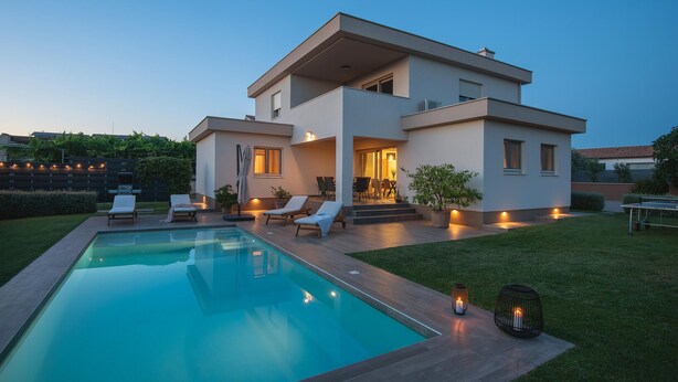 A modern two-story house with a swimming pool, outdoor seating, and a well-lit patio area. - Stunning home in Pula (Pula)