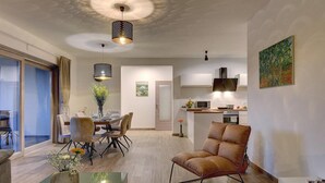 A modern living room with a dining area, a kitchen, and a large window. - Stunning home in Pula (Pula)