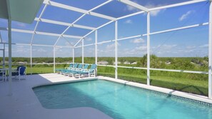 A covered swimming pool with a view of a green landscape. - Sunset villa on Golf Course - Private Pool (Davenport)