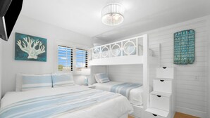 Een slaapkamer met een stapelbed, een nachtkastje, een lamp en een muur met inspirerende citaten.