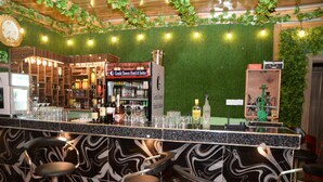 A bar area with a marble countertop, bar stools, and a sign for Gentle Towers Hotel & Suites. - gentle tower hotels (Lagos)