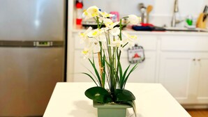 A kitchen with white cabinets, a stainless steel refrigerator, and a microwave. - Sequoia Riverway Studio, Visalia Central Nest, 45 minutes to Sequoia Visitor  (Visalia)