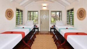 A room with two beds, a ceiling fan, and windows with shutters. - Mai Sunset Beach Resort (Naviti Island)