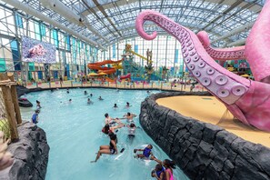 An indoor water park with a large octopus sculpture, slides, and a pool area. - Perdido Key Beach Escape - Pool, Spa, Golf, Private Beach, Arcade Games (Pensacola)