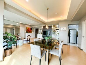 Relax in the open-plan living area with a dining table and comfortable seating, perfect for unwinding or entertaining.