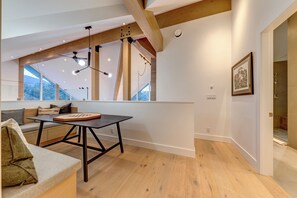 A modern interior with a wooden ceiling, a dining table, and a sofa. - Located overlooking the Whistler Golf Course, mountain charm, unbeatable views (Whistler)